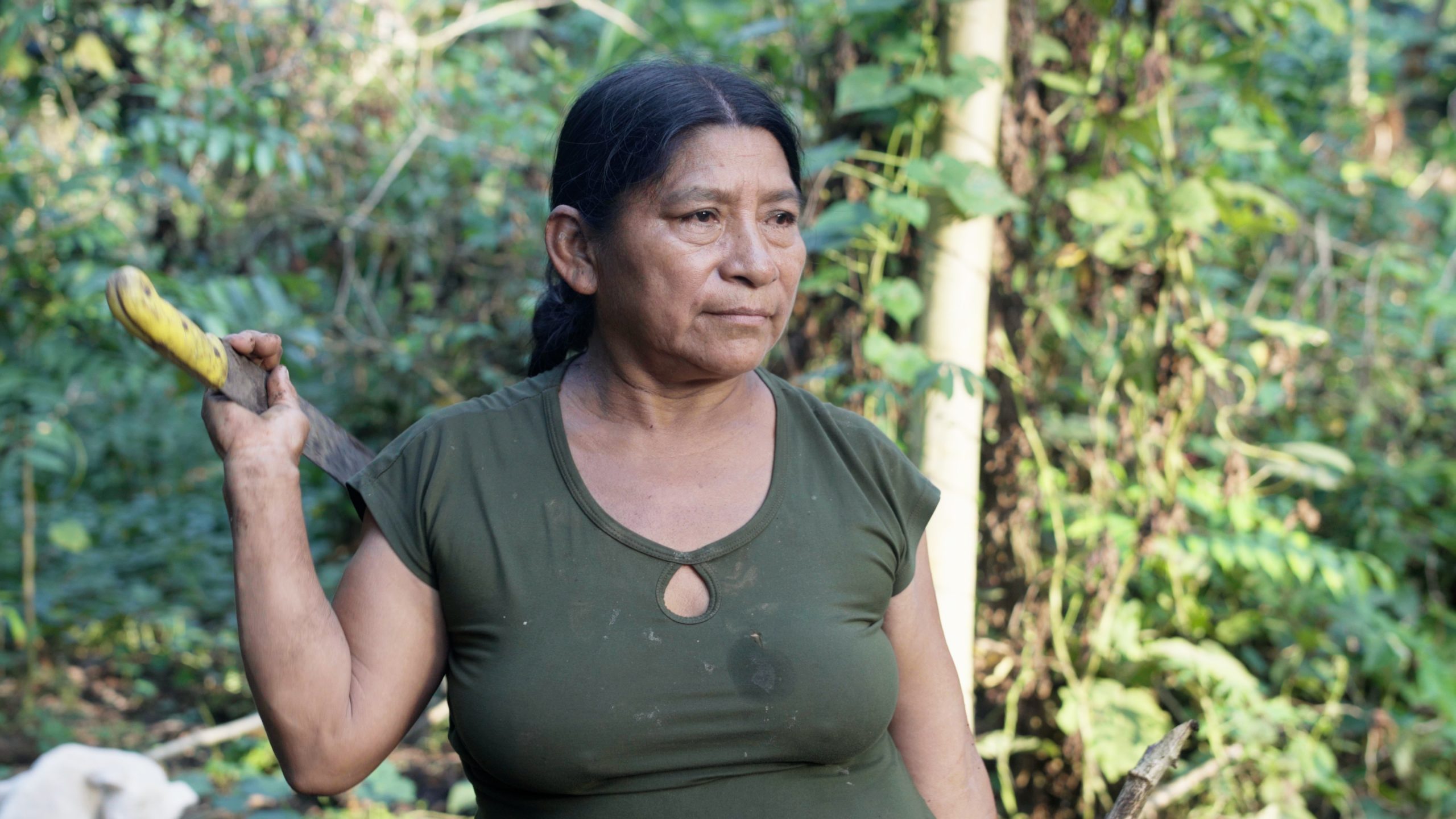 woman standing with machete in rainforst